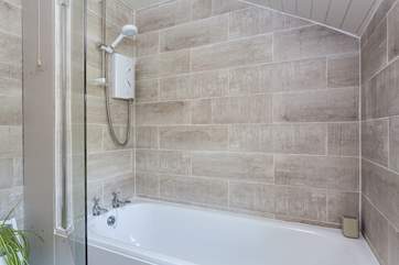The Bathroom has a bath, with a fitted shower.