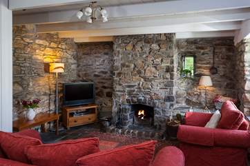 The lounge is cosy, warm, and has a roaring open fire to snuggle up in front of.