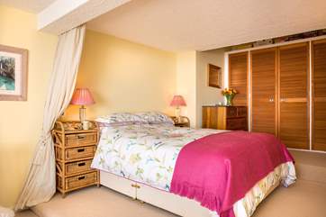 The bedroom-area is open to the rest of the apartment but can be curtained off if required.