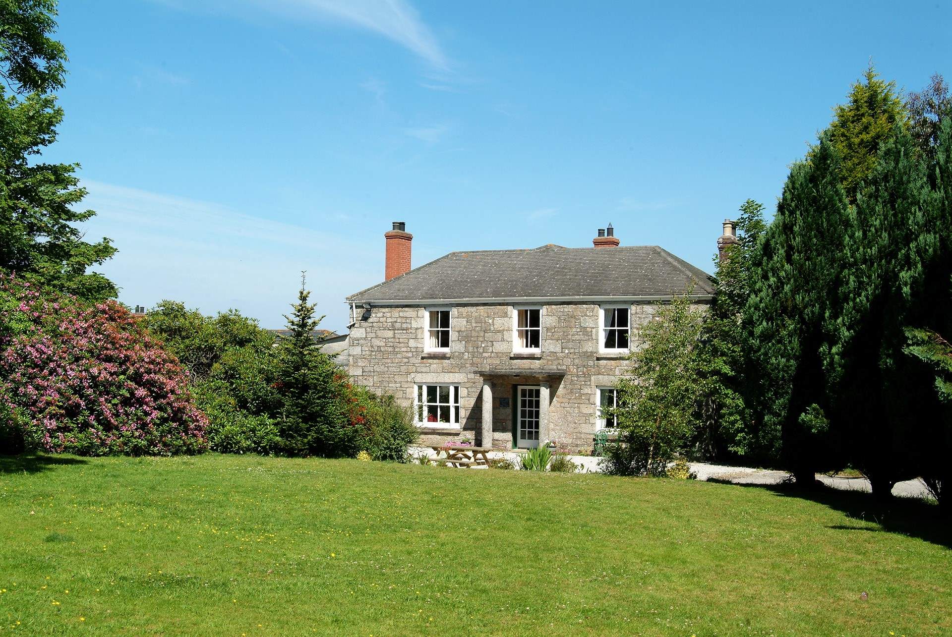 The house is set in spacious, lawned grounds.