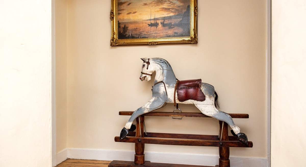 A charming rocking horse can be found on the landing. 