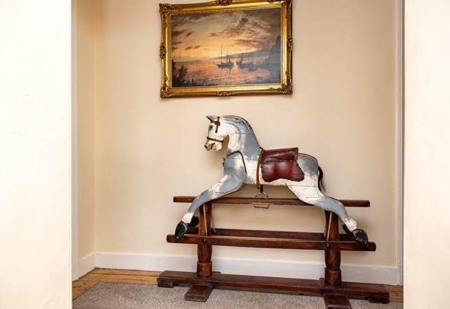 A charming rocking horse can be found on the landing. 