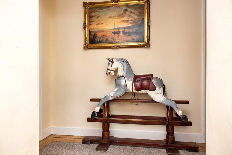 A charming rocking horse can be found on the landing. 
