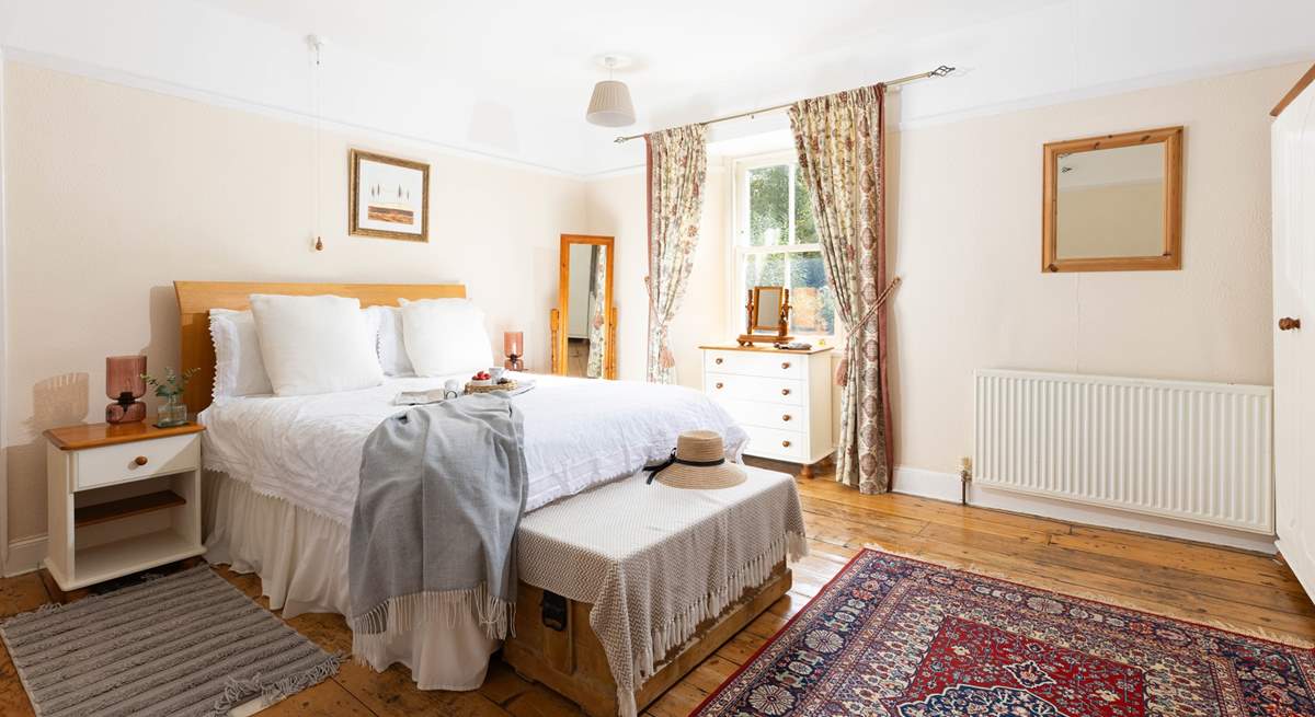 This large bedroom has a comfy double bed and views over the garden (Bedroom 1). 