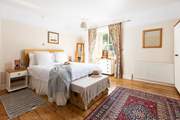 This large bedroom has a comfy double bed and views over the garden (Bedroom 1).
