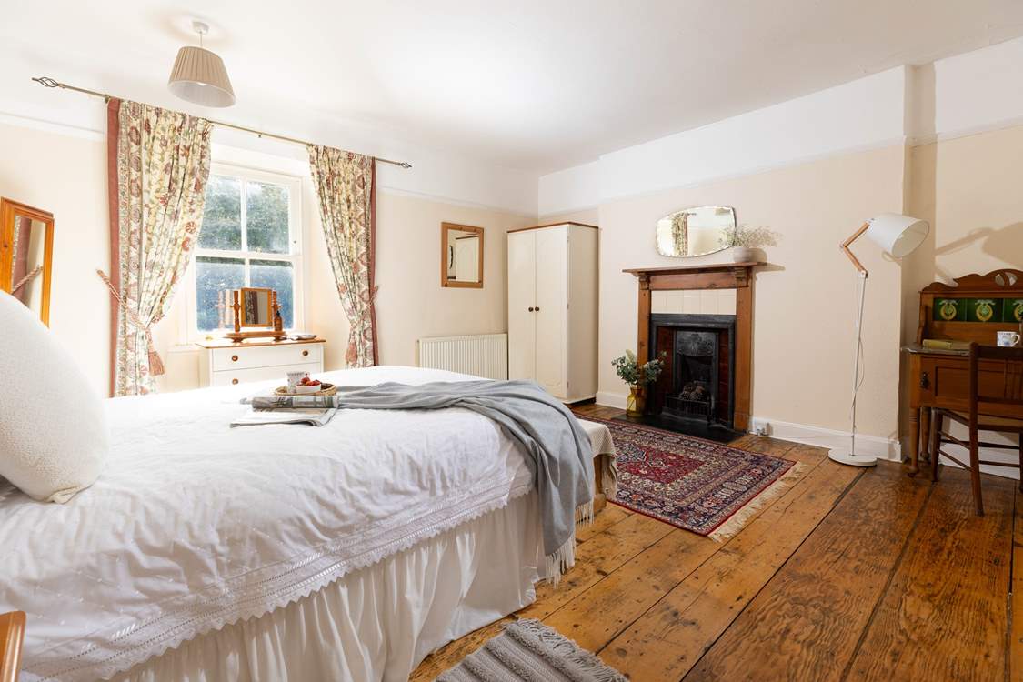 This gorgeous large bedroom has a stunning ornamental fire place.