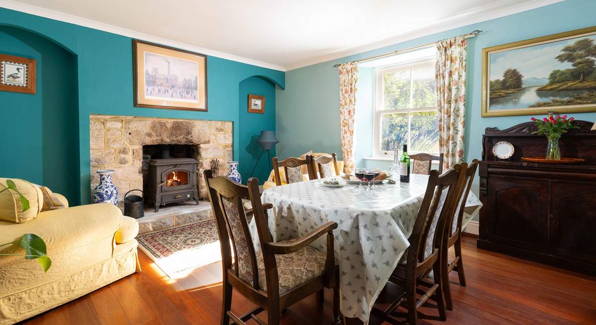 The cosy dining room is the perfect spot for long relaxing meals or snuggle up with a good book in front of the wood burner, 