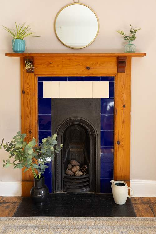 This bedroom also has a stunning ornamental fire place.
