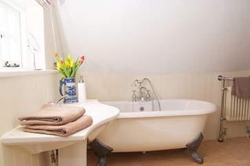 The master bedroom has a really spacious en suite with a wonderful roll-top bath and a separate shower cubicle too.