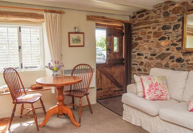 A stable-door opens into this lovely cottage, and a deep sofa to snuggle up in welcomes you on arrival.