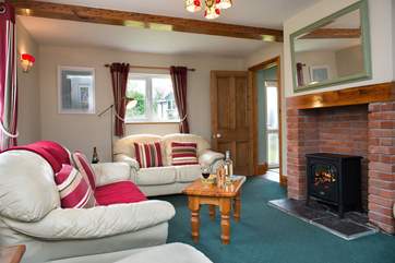 The electric fire makes the sitting-room warm and cosy all year round.