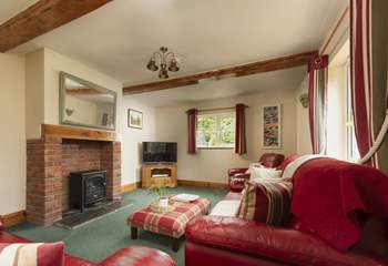 The wood-burner effect electric stove makes the sitting-room warm and cosy all year round.