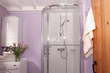 The modern shower-room doubles as a useful utility-room.