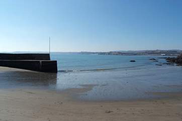 Polkerris is a tiny harbour close to Fowey with a sandy beach as the tide drops back.