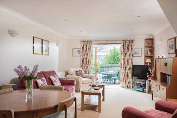 The open plan living-room is beautifully furnished and filled with light.