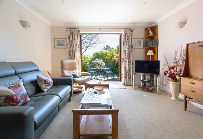 Patio doors lead out to the sunny courtyard.