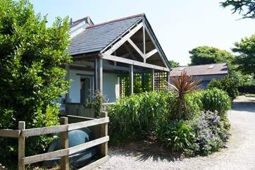 The covered deck provides a shady outdoor seating-area on hot sunny days.