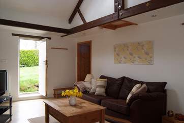 A door from the living-room opens out to the enclosed garden beside the cottage.