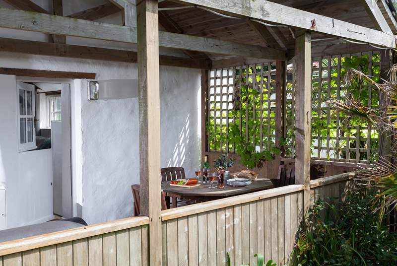 The covered deck provides a shady outdoor seating-area on hot sunny days.