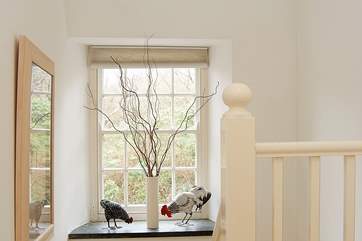 A large landing window makes the hall and stairway very light.