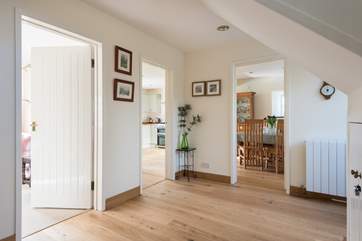 Looking from the entrance hall into the sitting-room and kitchen/dining-room.