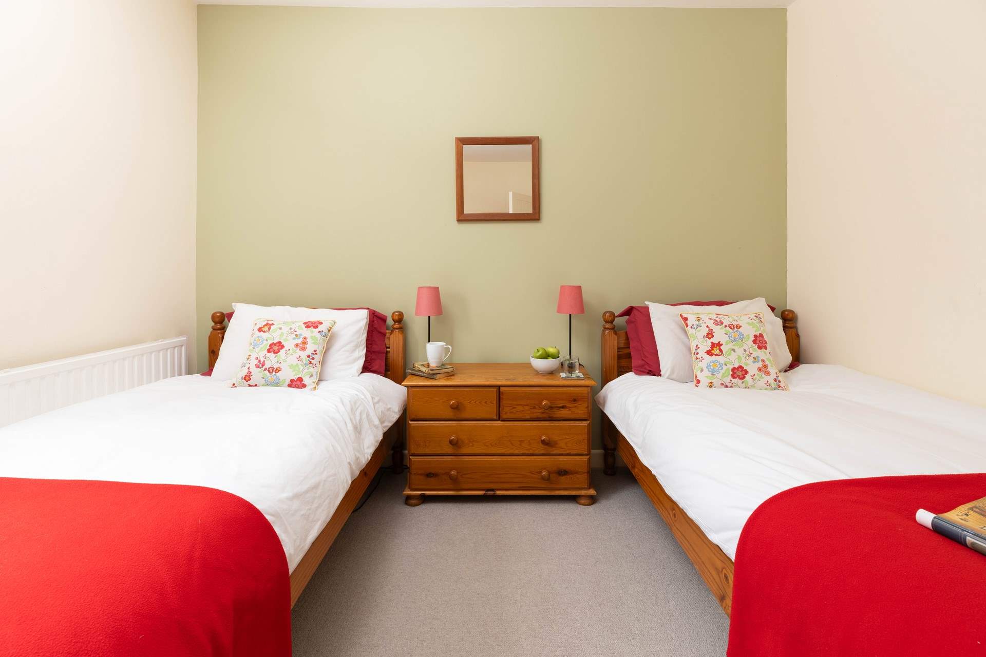 Calming tones of greens and reds in Bedroom 3. 