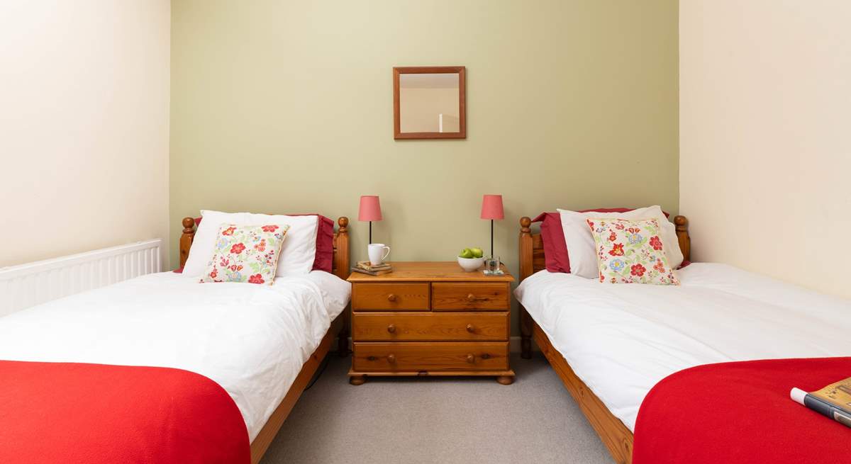 Calming tones of greens and reds in Bedroom 3. 