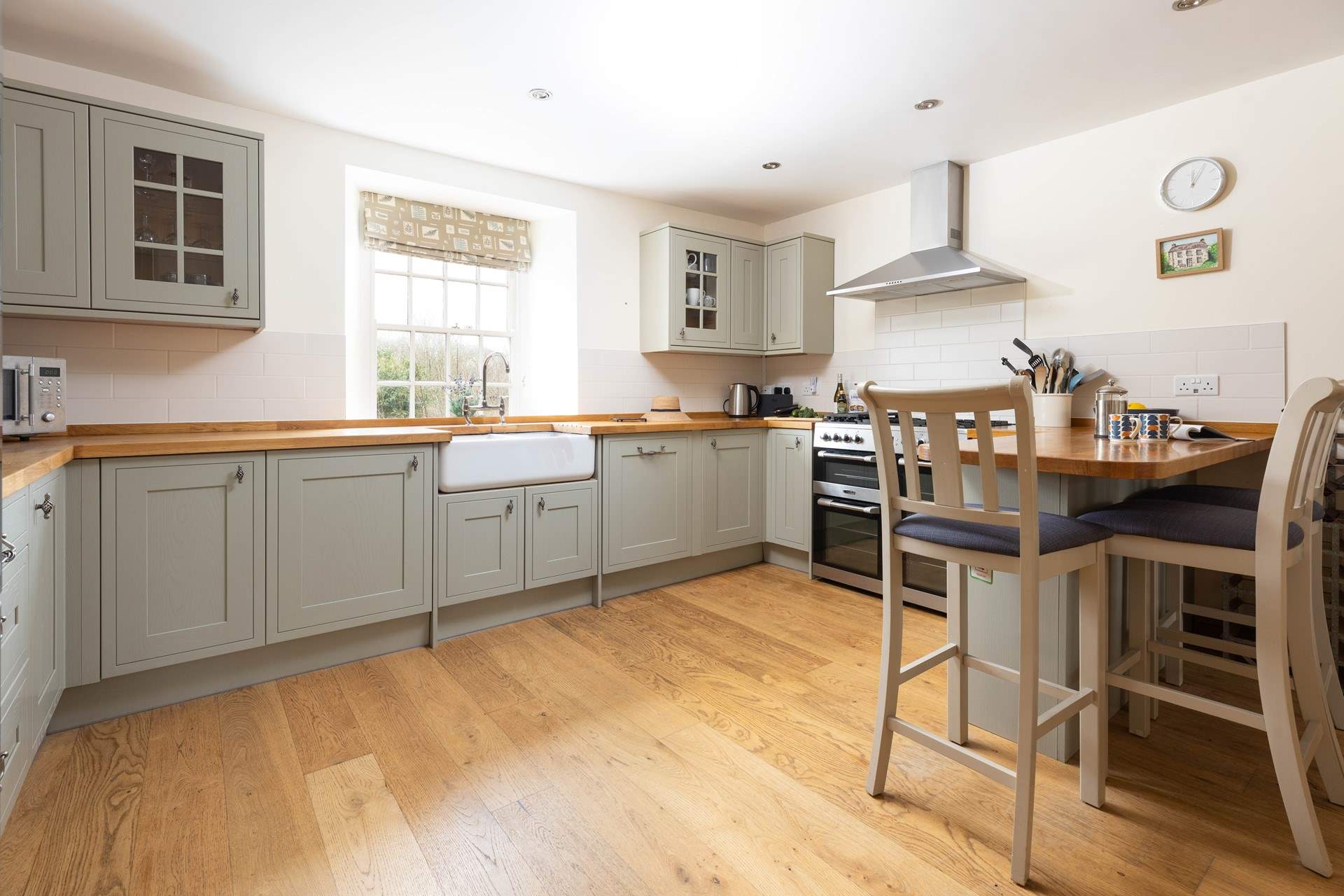 The shaker style kitchen over looks the pretty garden. 