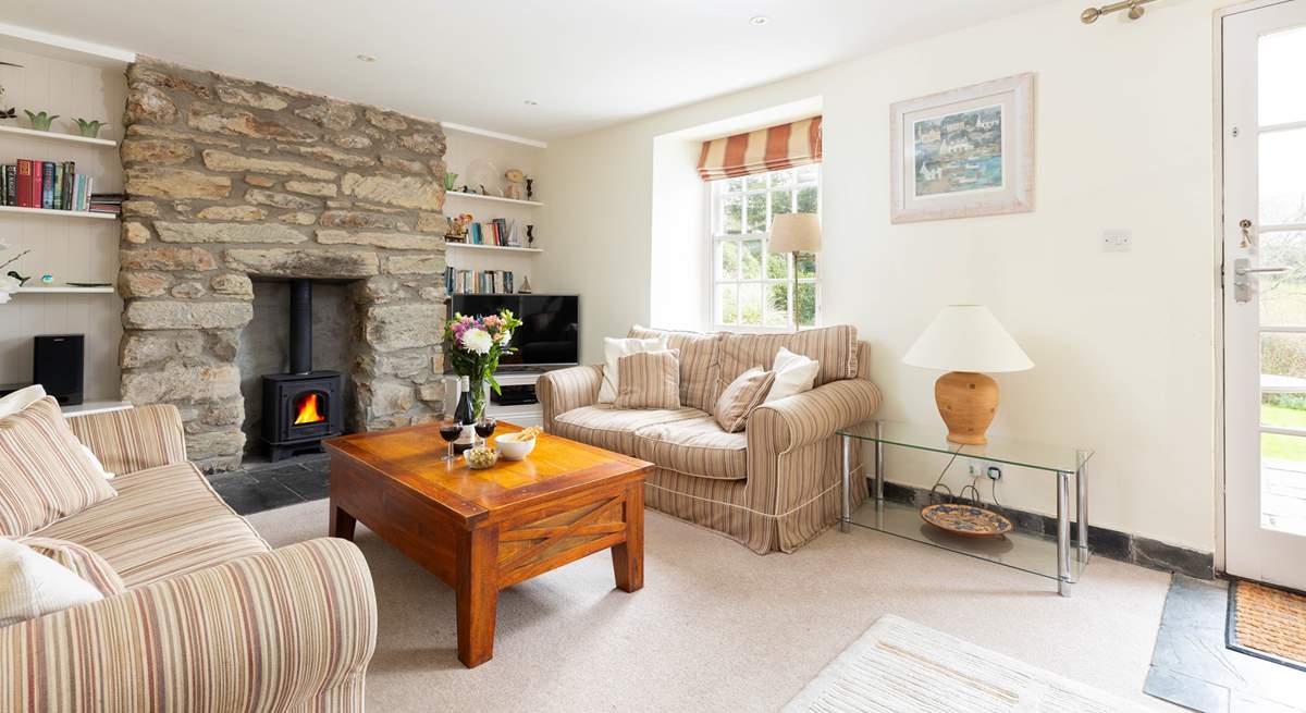 The comfortable sitting room has a cosy gas effect wood-burner for the winter months and a door that opens to the sunny terrace. 