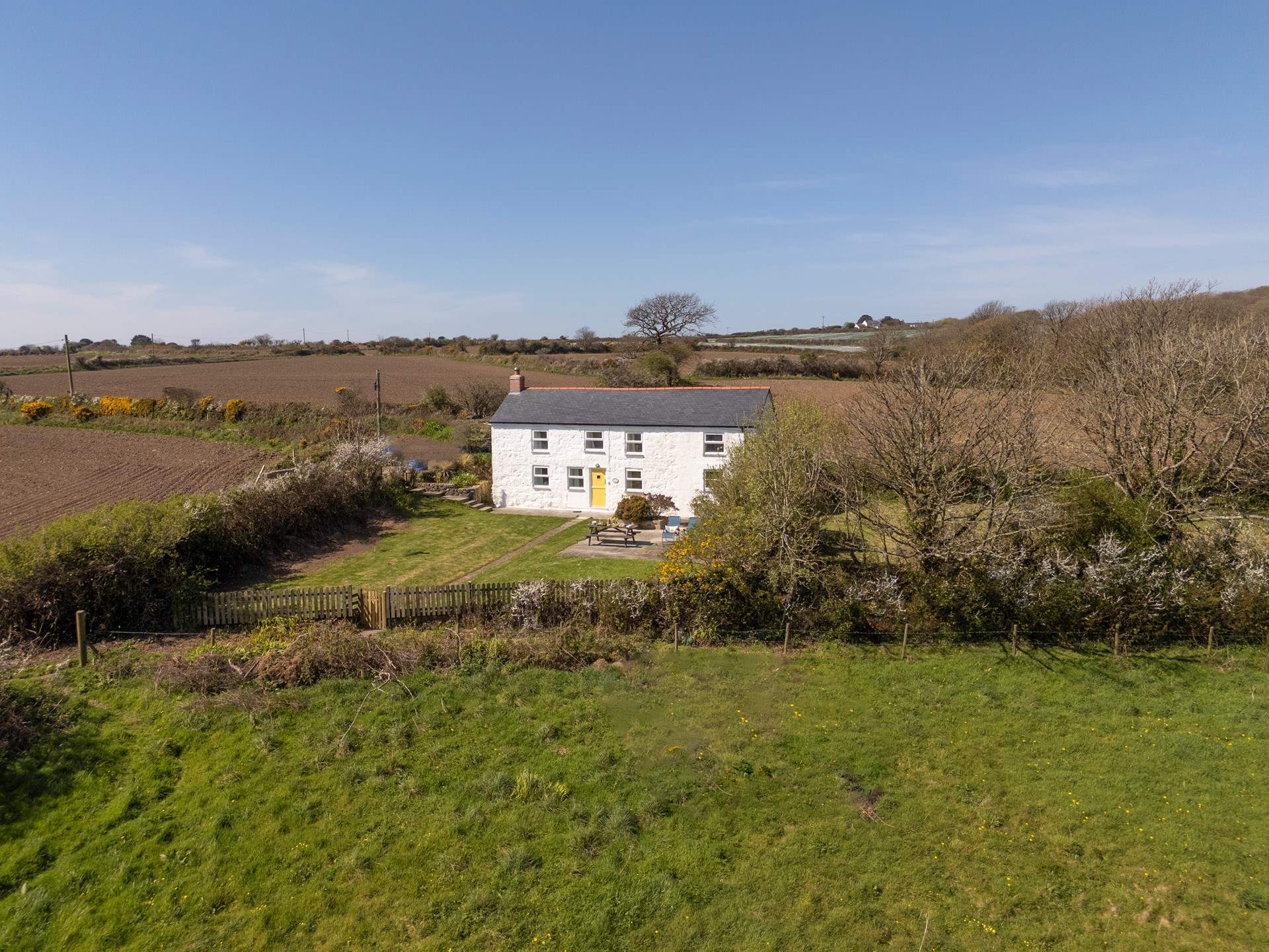 An aerial view of the cottage, showing its tranquil rural location once part of a working farm.