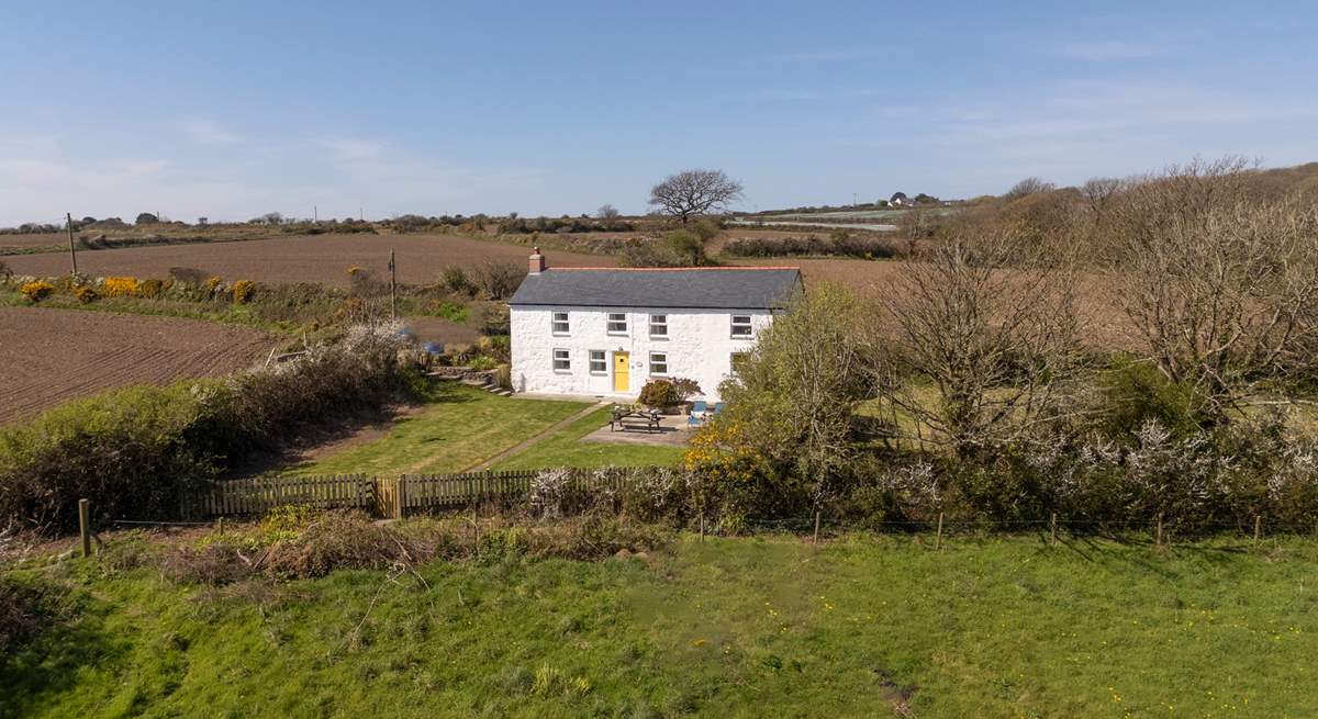 An aerial view of the cottage, showing its tranquil rural location once part of a working farm.