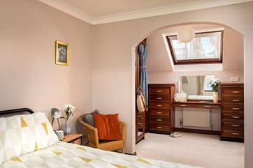 Bedroom 1 has a dressing-area with ample storage space.