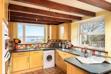 The well-equipped kitchen/diner has wonderful views over the harbour.