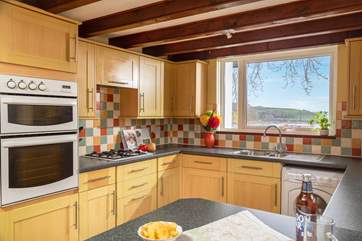 The kitchen has a useful breakfast-bar.