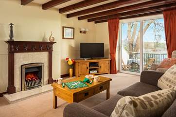 The spacious sitting-room has doors onto the terrace (the fire is ornamental only).