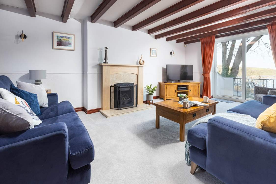 The spacious sitting-room has doors onto the terrace and an ornamental fire.