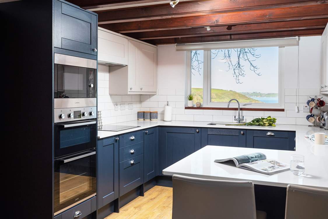 The well-equipped kitchen/diner has wonderful views over the harbour.