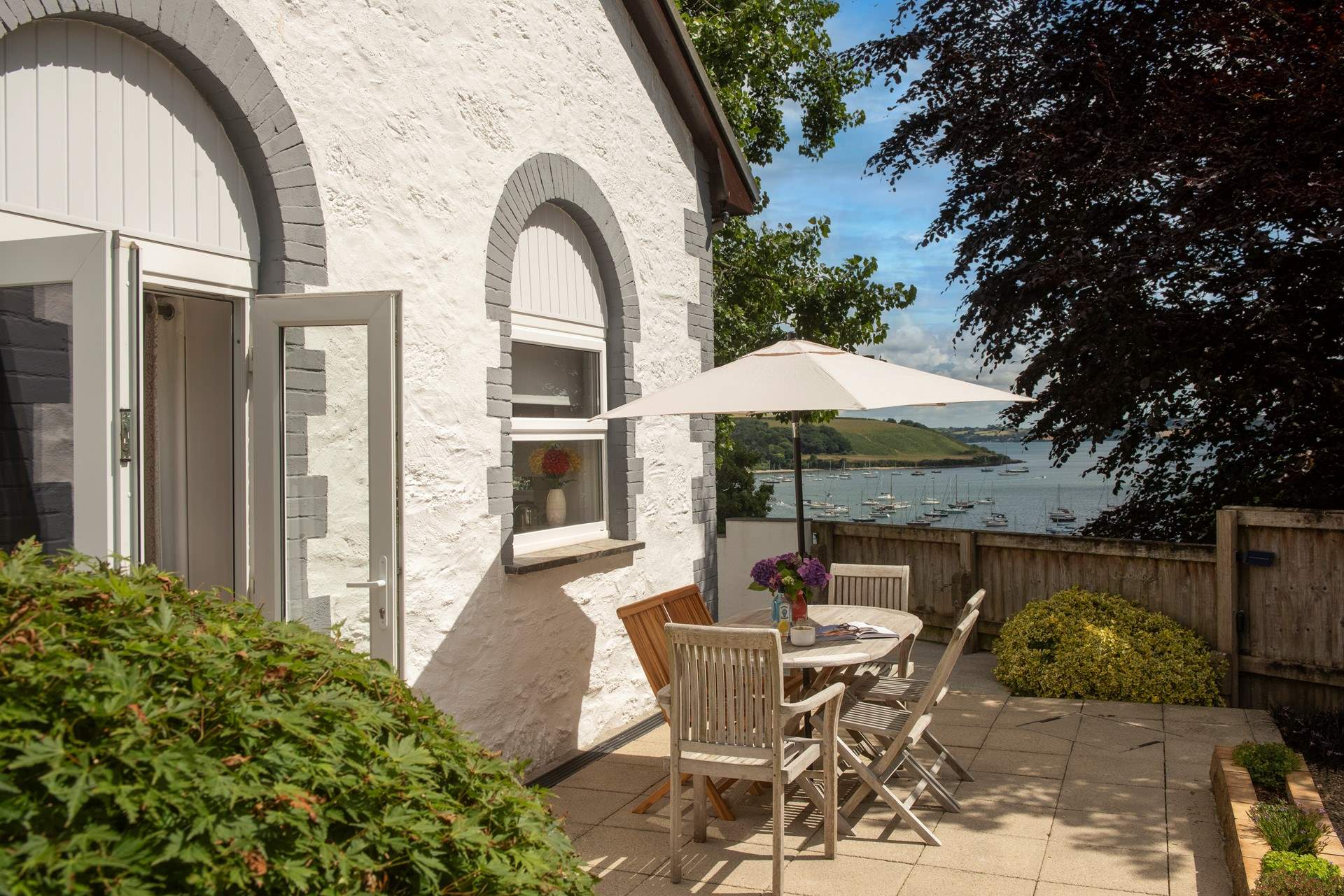 Double doors open to the wrap around terrace. 