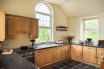 The well-equipped kitchen-area has a slate floor.