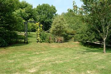 An archway leads from the garden to a grassy orchard (the owners make their own apple juice).