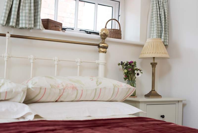 A gorgeous Victorian-style bed, wonderfully inviting!