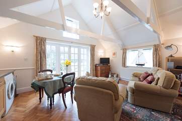 The high apex ceiling has original beams and a high window that allows light to flood in.