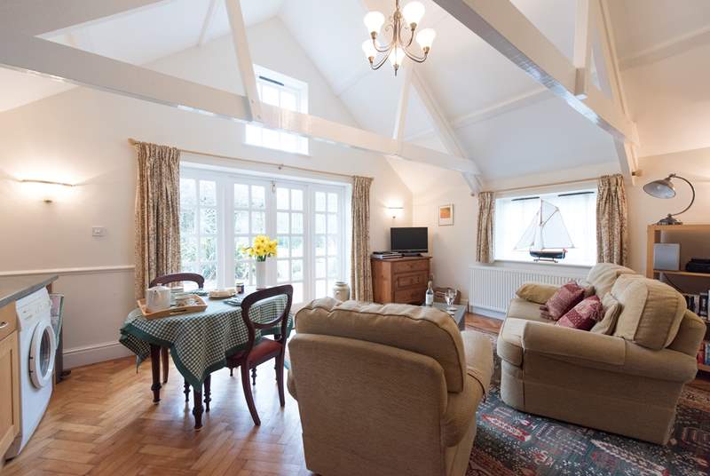 The high apex ceiling has original beams and a high window that allows light to flood in.