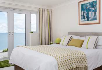 The principal bedroom is furnished in soft yellow's and whites.