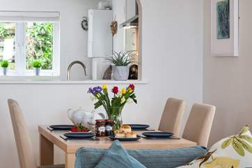 The kitchen looks through into the open plan living-area.