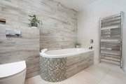 The stylish en suite bathroom tempts unhurried bubble soaked baths after a long day luxuriating on the golden sandy beaches nearby.