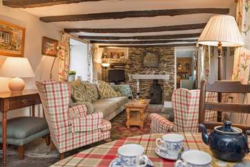 The cottage retains many of its original features with flagstone floors and rustic beams.