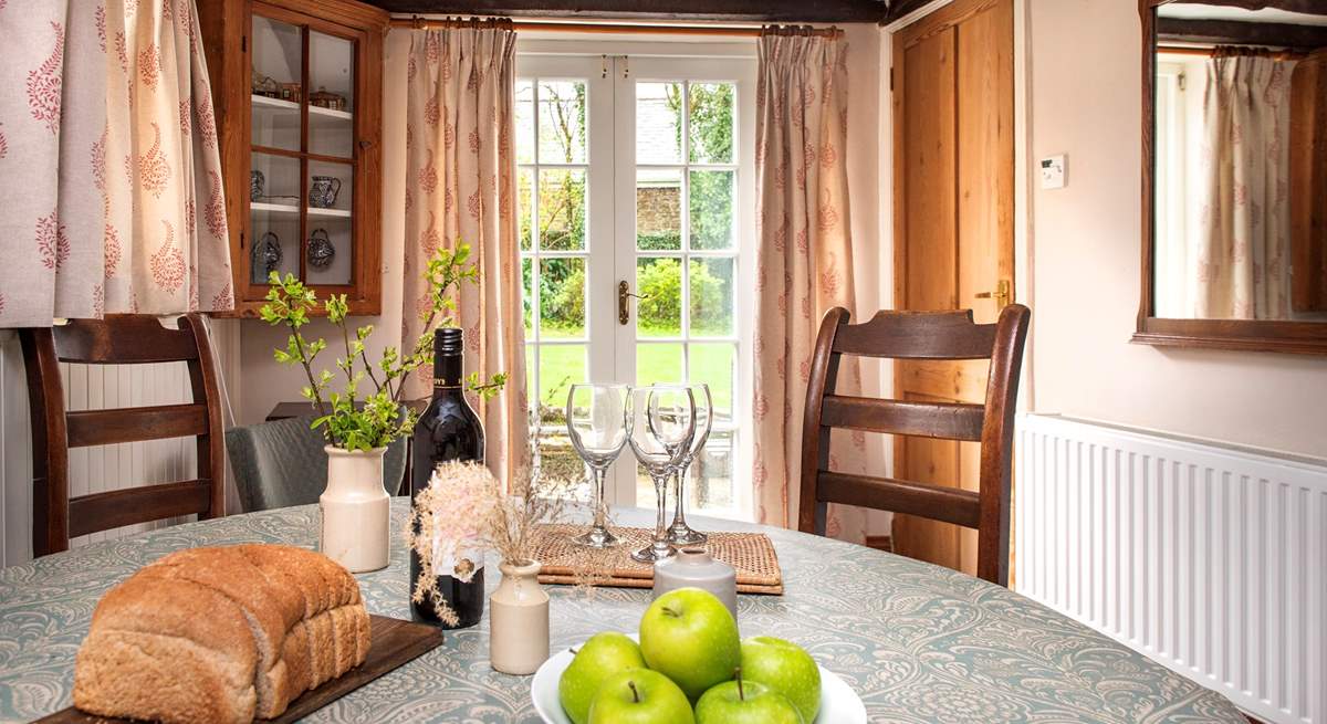 French doors from the dining-area lead out to the enclosed garden.