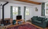 The sitting/dining-room welcomes you to the cottage, the wood-burner is perfect for a cosy evening in. - Thumbnail Image