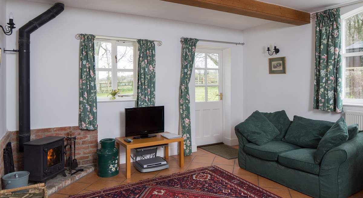 The sitting/dining-room welcomes you to the cottage, the wood-burner is perfect for a cosy evening in.